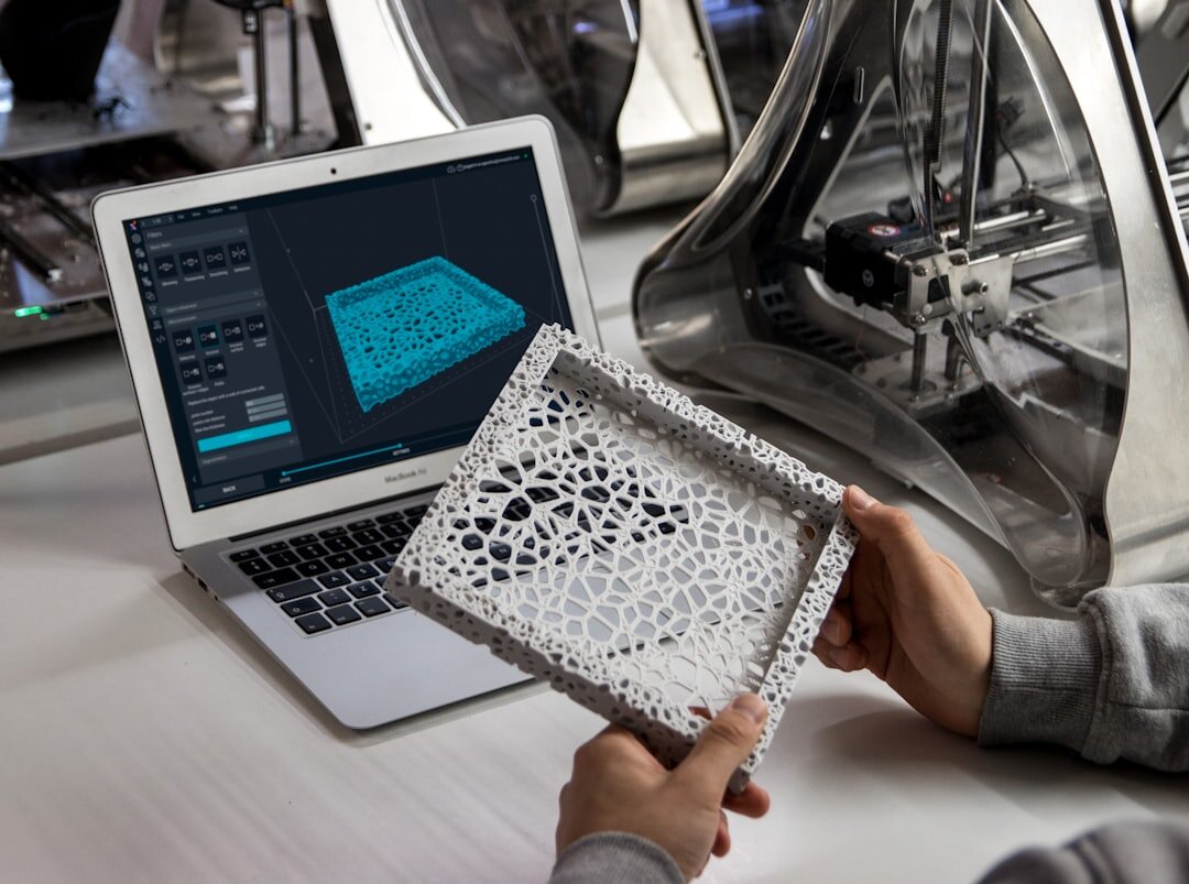 Engineer working on CAD software on a laptop at a desk